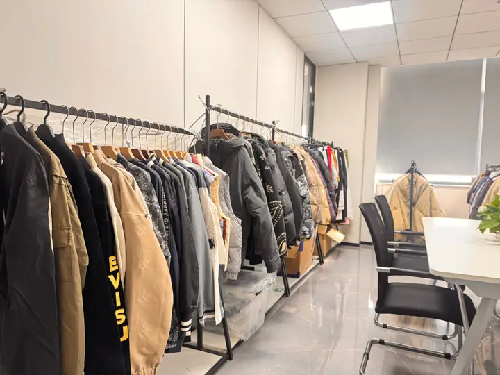 Apparel sample room with racks of jackets and outerwear