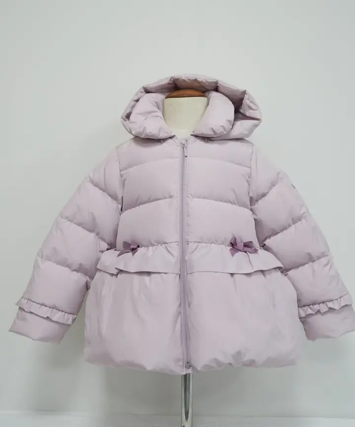 Light lilac quilted children’s hooded jacket with ruffle and bow details
