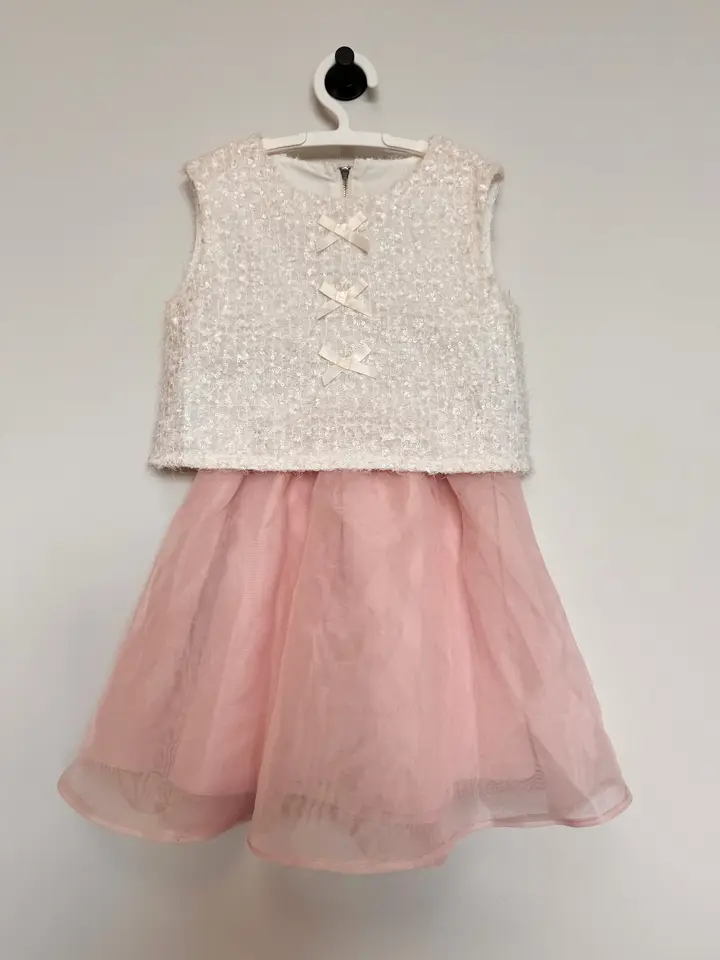 Children’s dress with an ivory sequin bodice and pink tulle skirt
