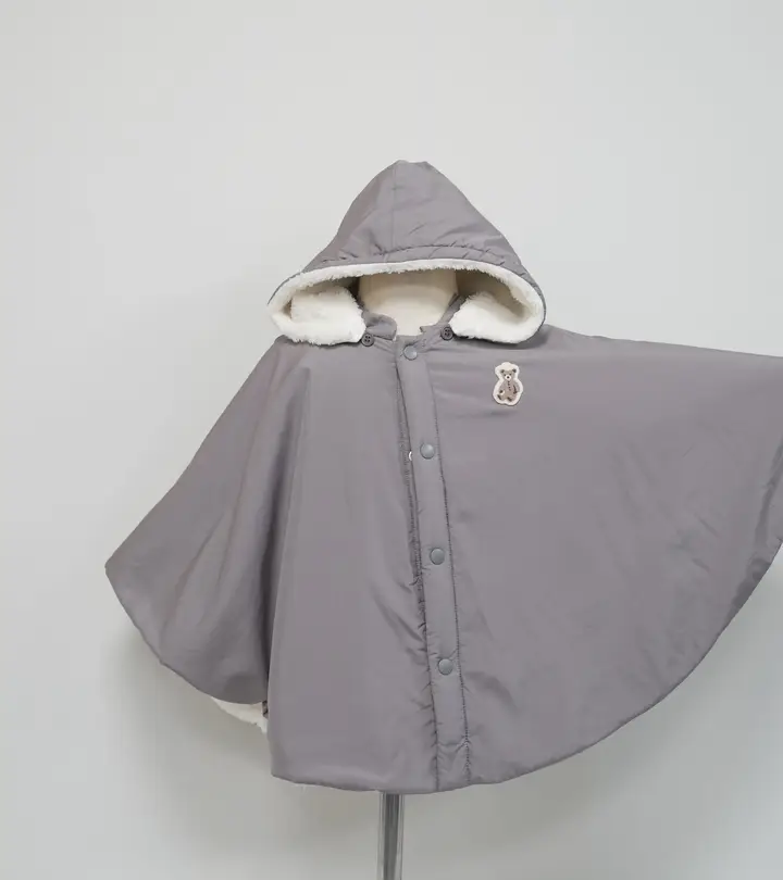 Gray hooded children’s cape with plush trim and a bear patch