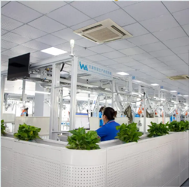 Garment production floor with an overhead handling system and sewing workstations