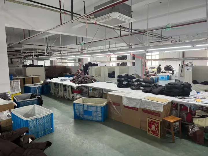 Quilted outerwear work area with garments sorted on tables