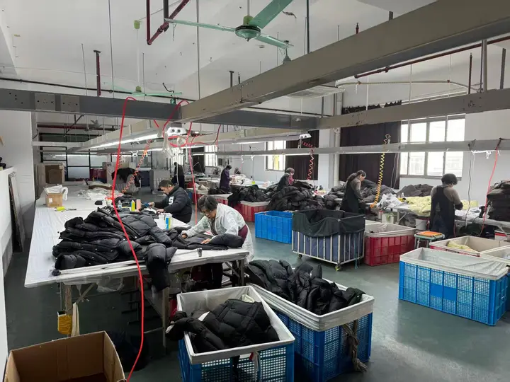 Quilted outerwear work area with garments arranged in bins and on tables
